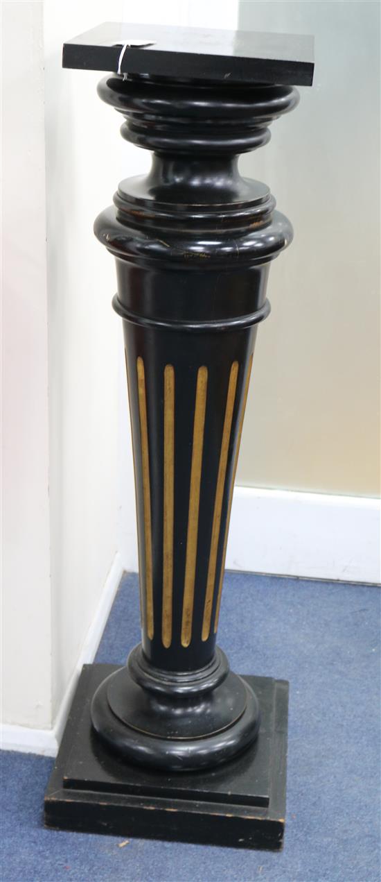 An ebonised and parcel gilt statuary pedestal, with rectangular top, on turned and reeded support and rectangular H.112cm